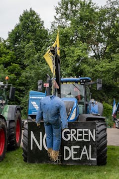 Effigy lynched beside sign 'no green deal'