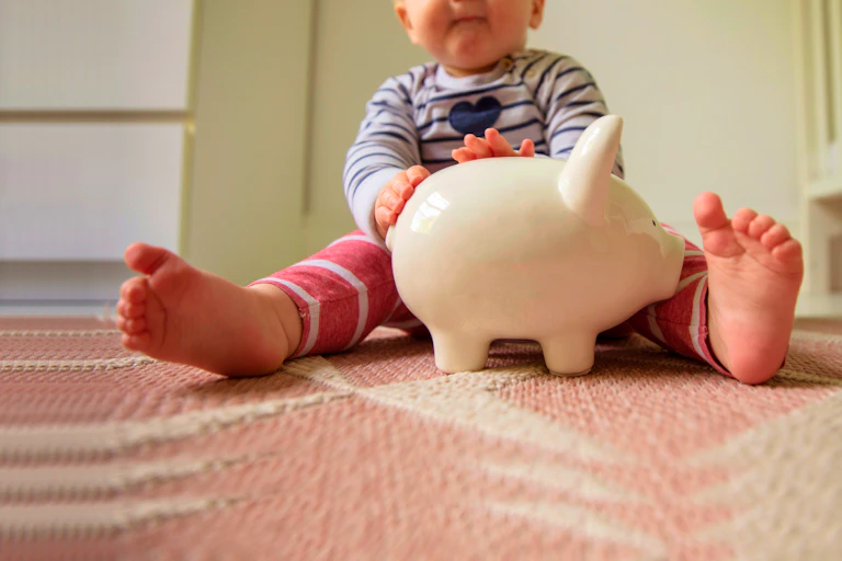 Baby with piggy bank