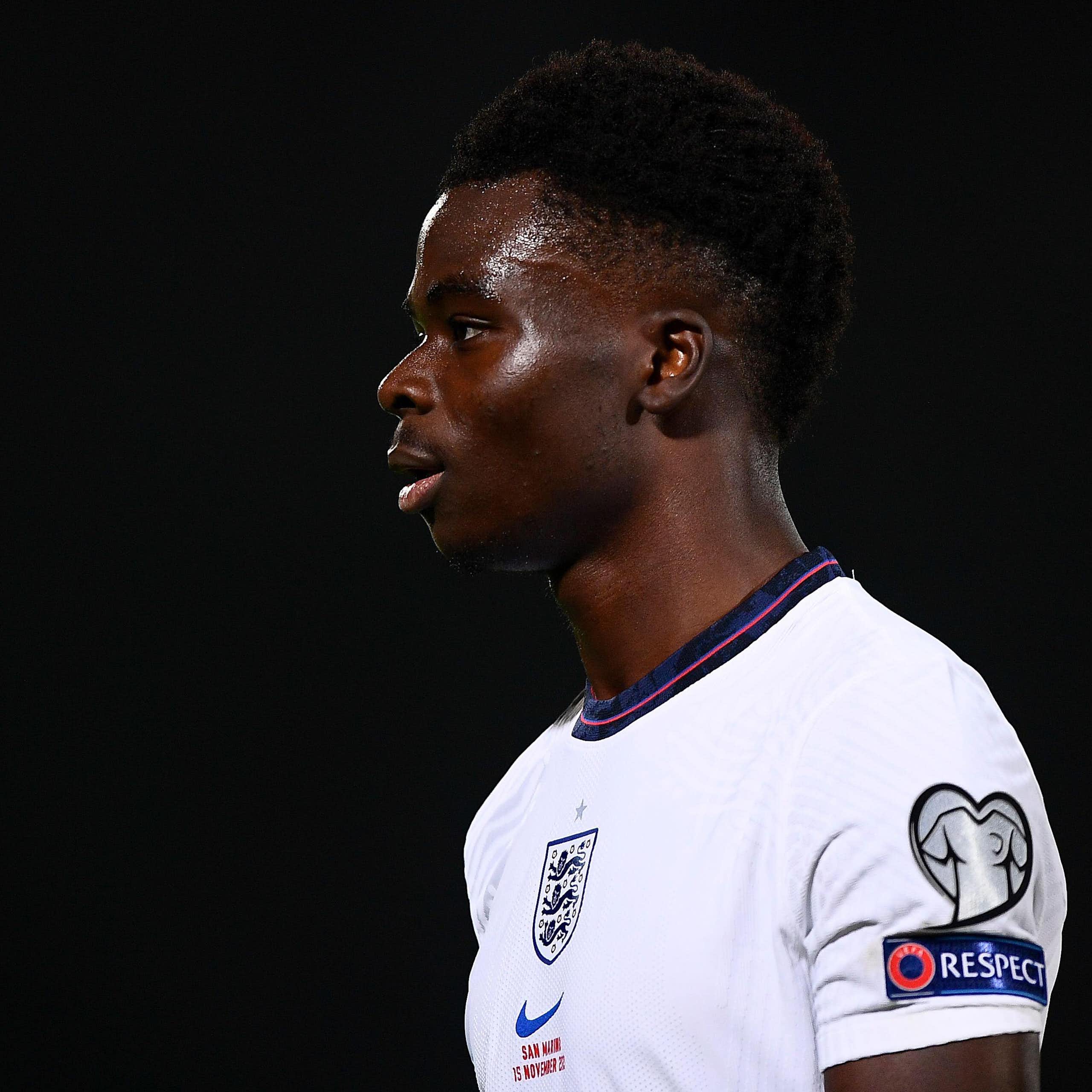 Bukayo Saka, a young black English player in an England shirt. 