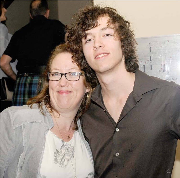 A woman wearing glasses and a young man.