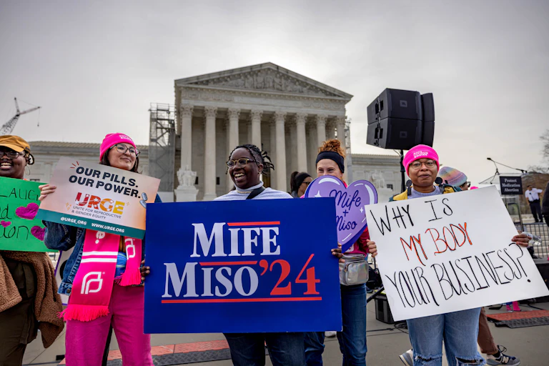 Demonstrators hold up signs related to abortion rights in front of the SCOTUS building.