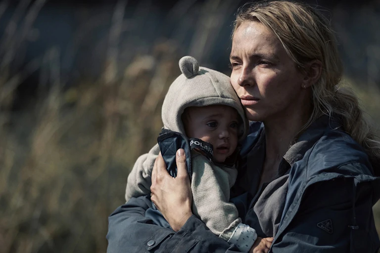 Jodie Comer holds a baby