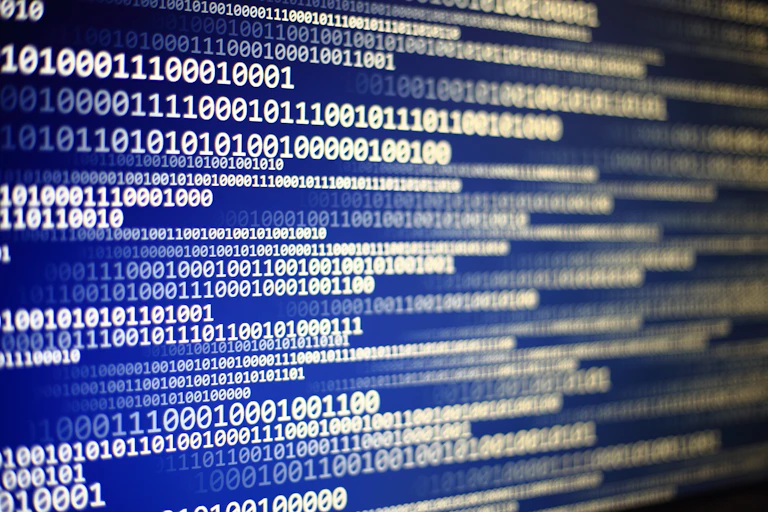 A screen showing binary code in blue, white and yellow colours.