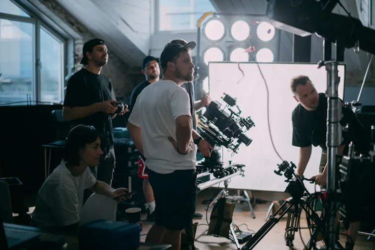 A group of men on a TV set