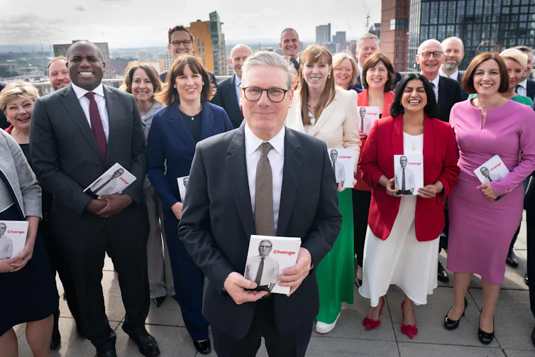 Keir Starmer and his shadow cabinet, holding copies of their election manifesto.