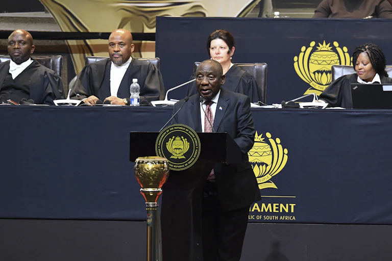 A man speaks at a podium.