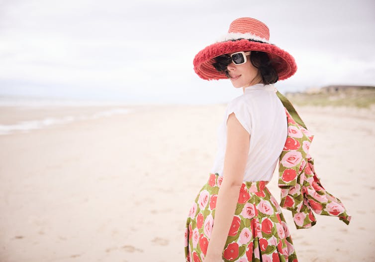 Production image: a woman on the beach.