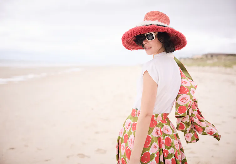 Production image: a woman on the beach.
