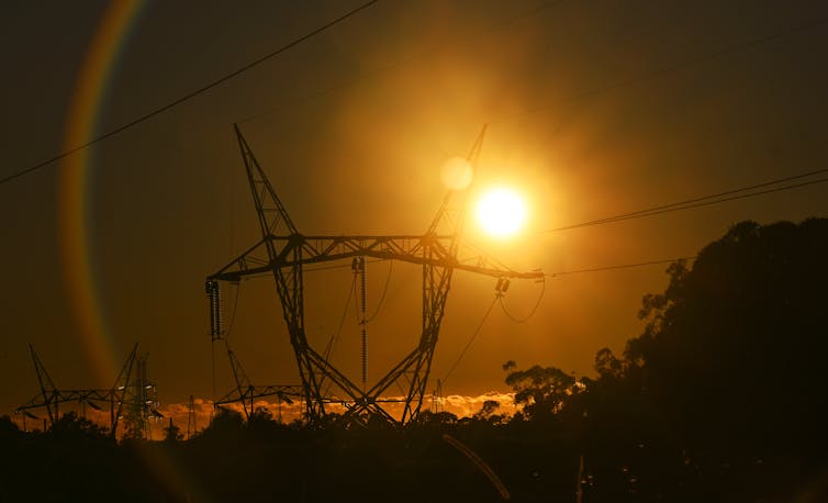 electricity transmission tower at sunset