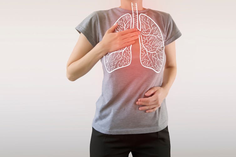 person stands with diagrams of lungs superimposed on chest