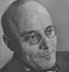 A portrait of Karl Polanyi wearing circular glasses.