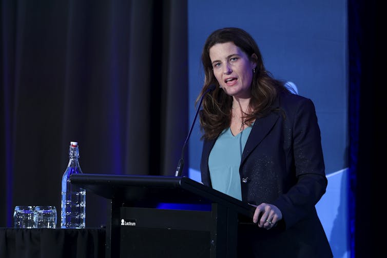 Nicola Willis speaking at a lectern
