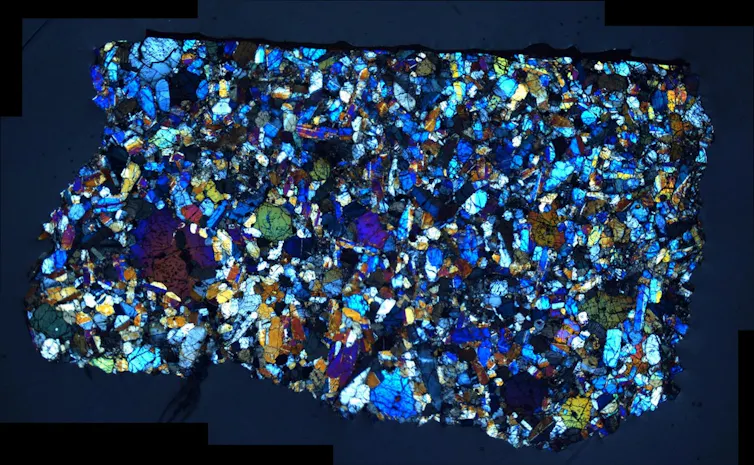 A rock made up of lots of smaller, different colored grains.