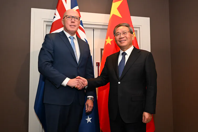 two men in suits shaking hands