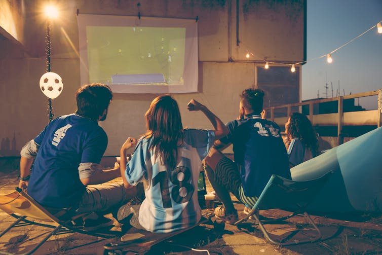 Friends watching a football game together