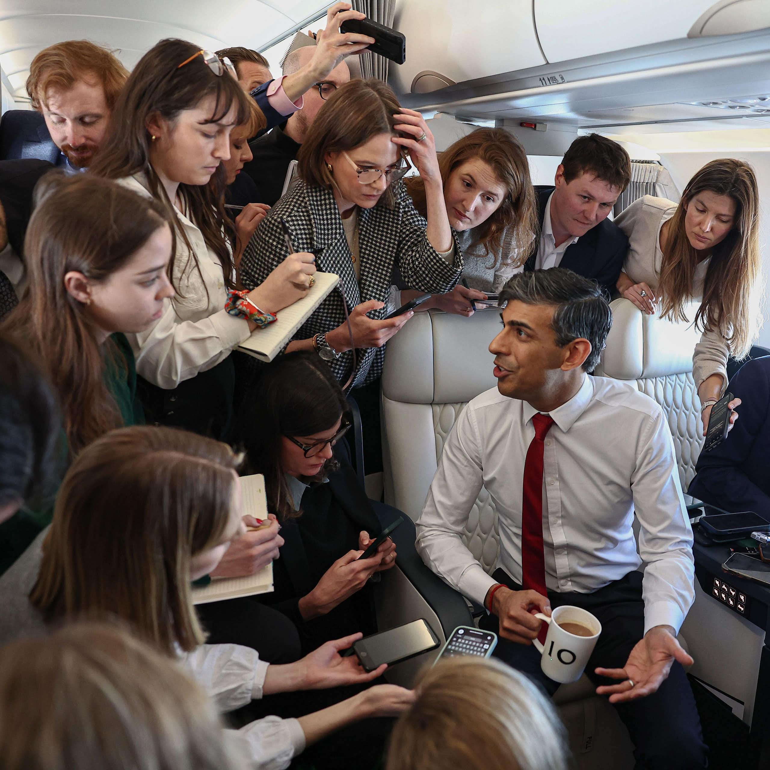 Rishi Sunak talking to journalists on a plane.