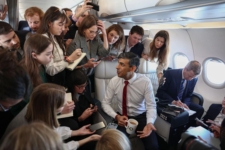 Rishi Sunak talking to journalists on a plane.