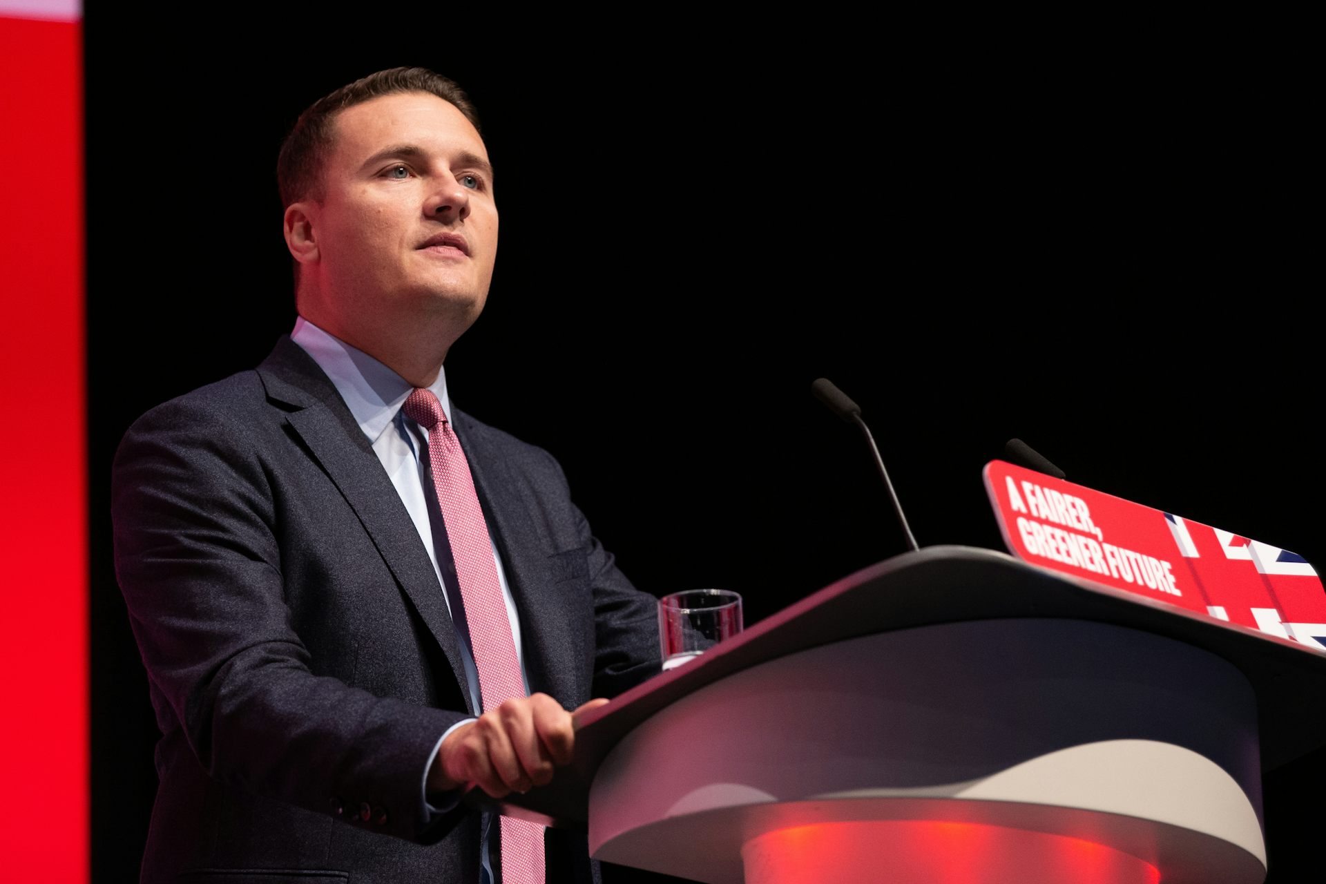 Wes Streeting standing at a lectern