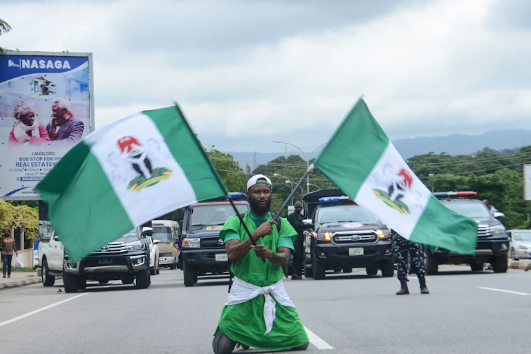 A man holding two flags