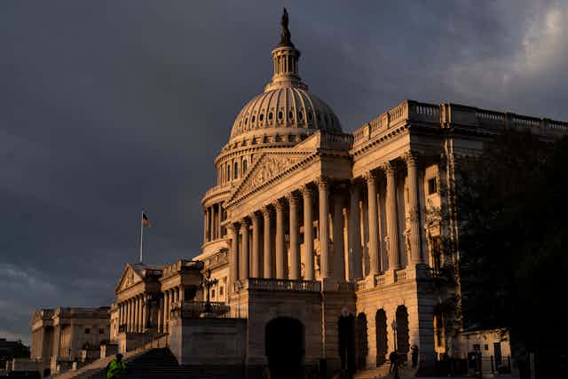 The U.S. Capitol, shown against dark clouds.
