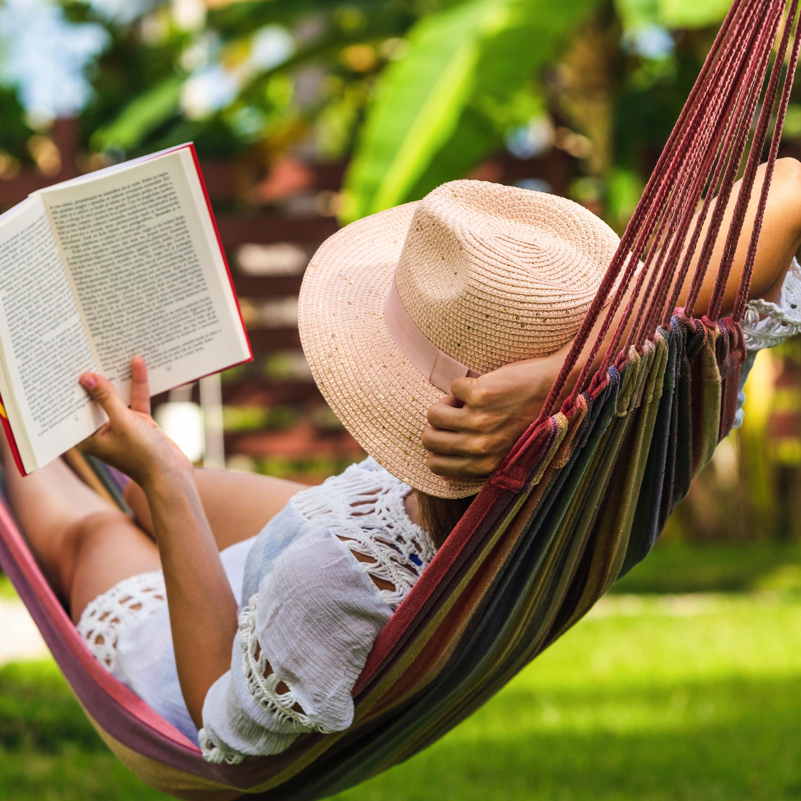 A woman in a hammock with a book.