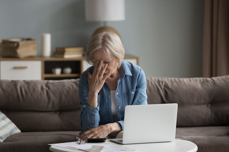Woman in despair as she reads a letter