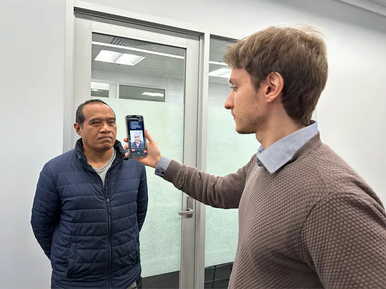 PhD scholar Guilherme Camargo de Oliveira (right) demonstrates the face screening tool with Visiting Associate Professor Nemuel Daniel Pah from RMIT University.