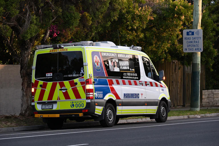 An ambulance parked on a street in Melbourne.