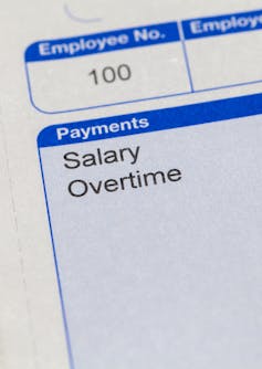 Super close up of payslip showing words salary and overtime