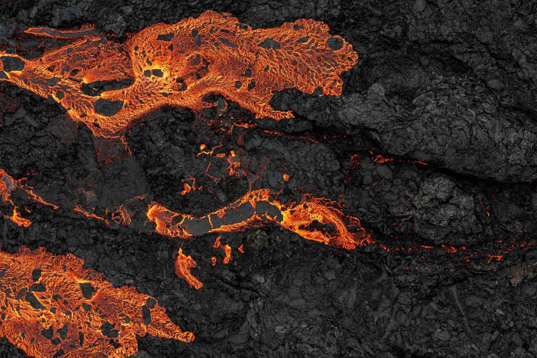 Photo of lava cooling and solidifying to rock