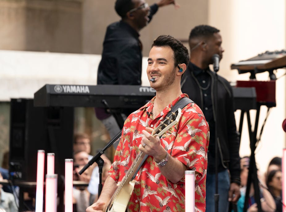 Kevin Jonas performs on stage.