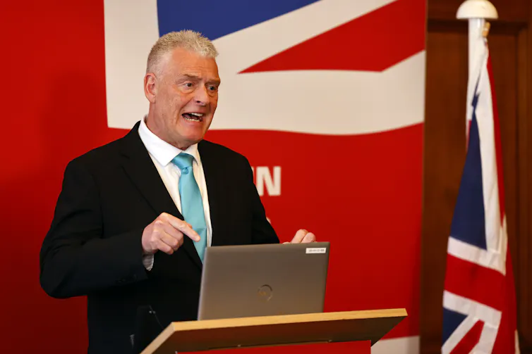 man in suit at lectern