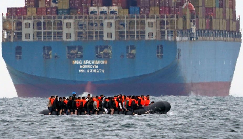 A small boat carrying what is thought to migrants near a tanker in the English Channel. 