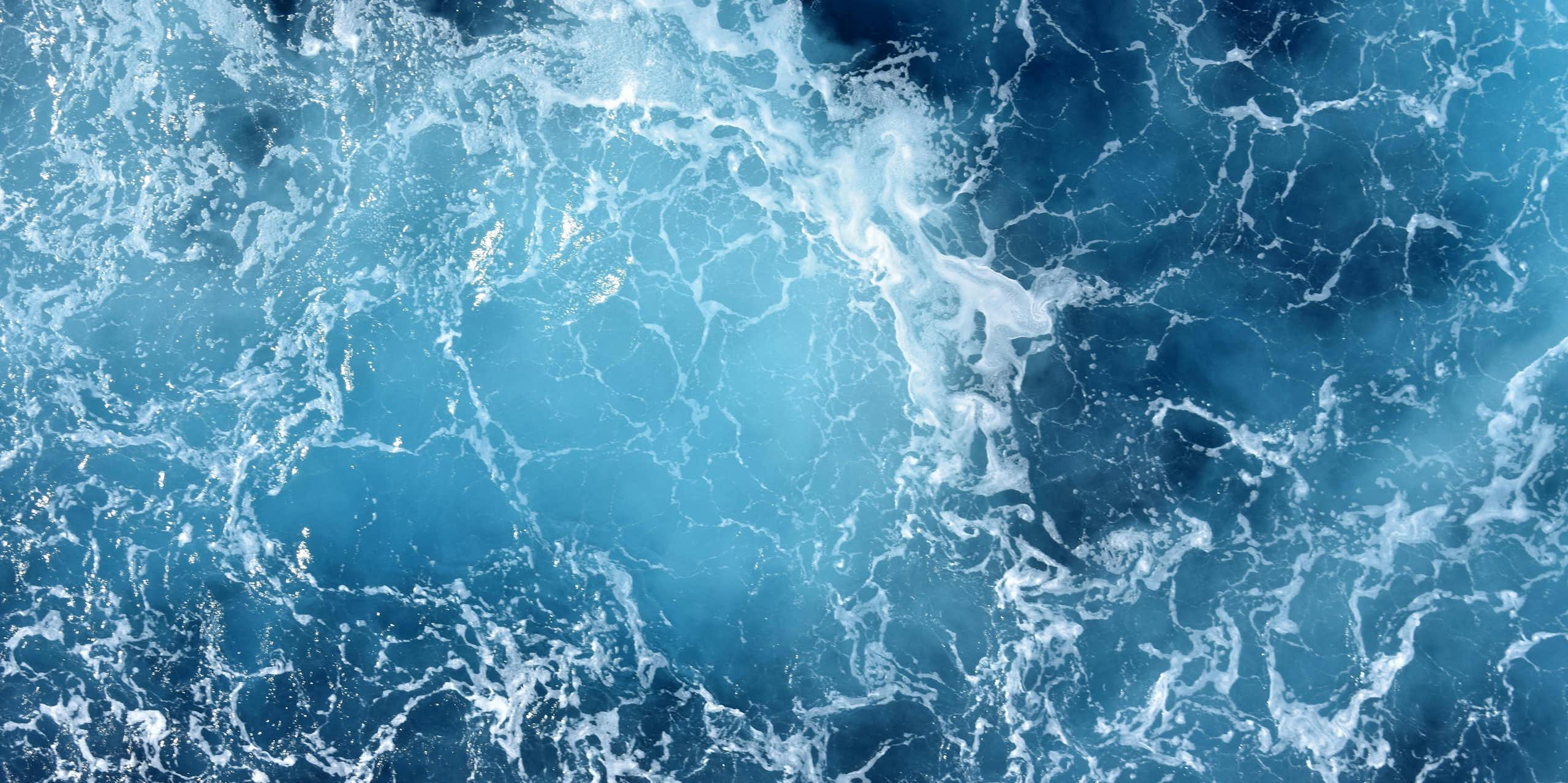 close up of blue ocean waves and white sea spray