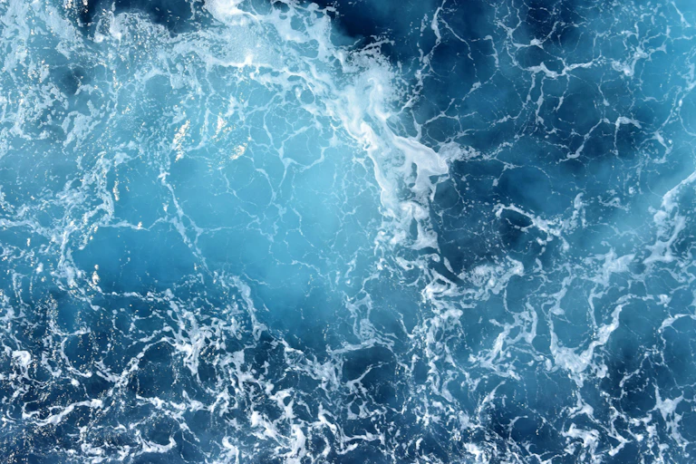 close up of blue ocean waves and white sea spray