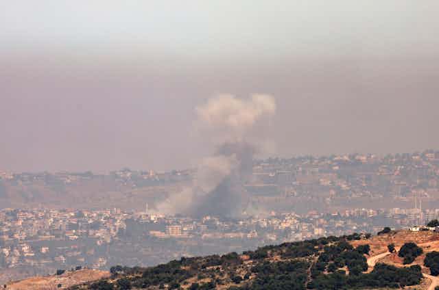 A column of smoke from an Israeli air strike in the southern Lebanese town of Khiam, 19 June 2024.