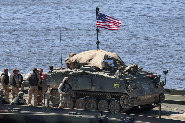 US soldiers with a tank and a US flag.