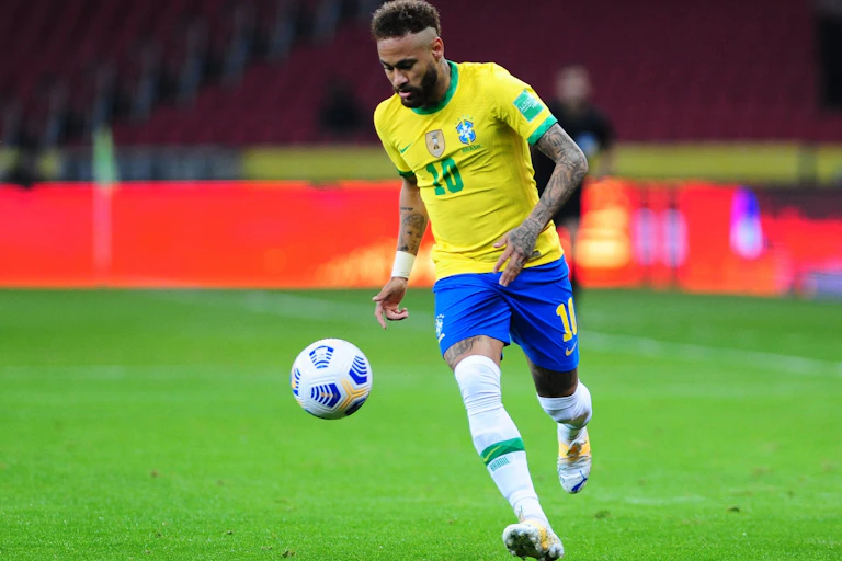 Brazil star Neymar dribbles a ball towards goal