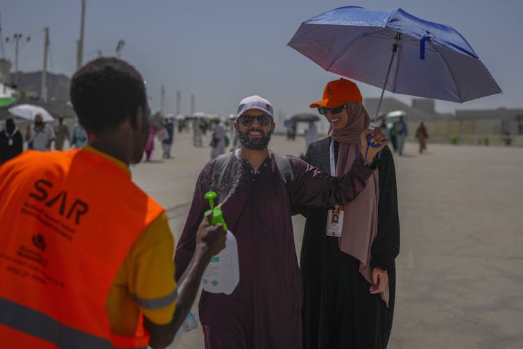 Amid scorching heat, 900 people died this week in Saudi Arabia. Climate change has made the Hajj pilgrimage more risky 2 A pilgrim receives cold water spray