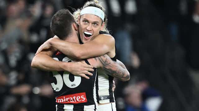 Collingwood players celebrate another remarkable comeback