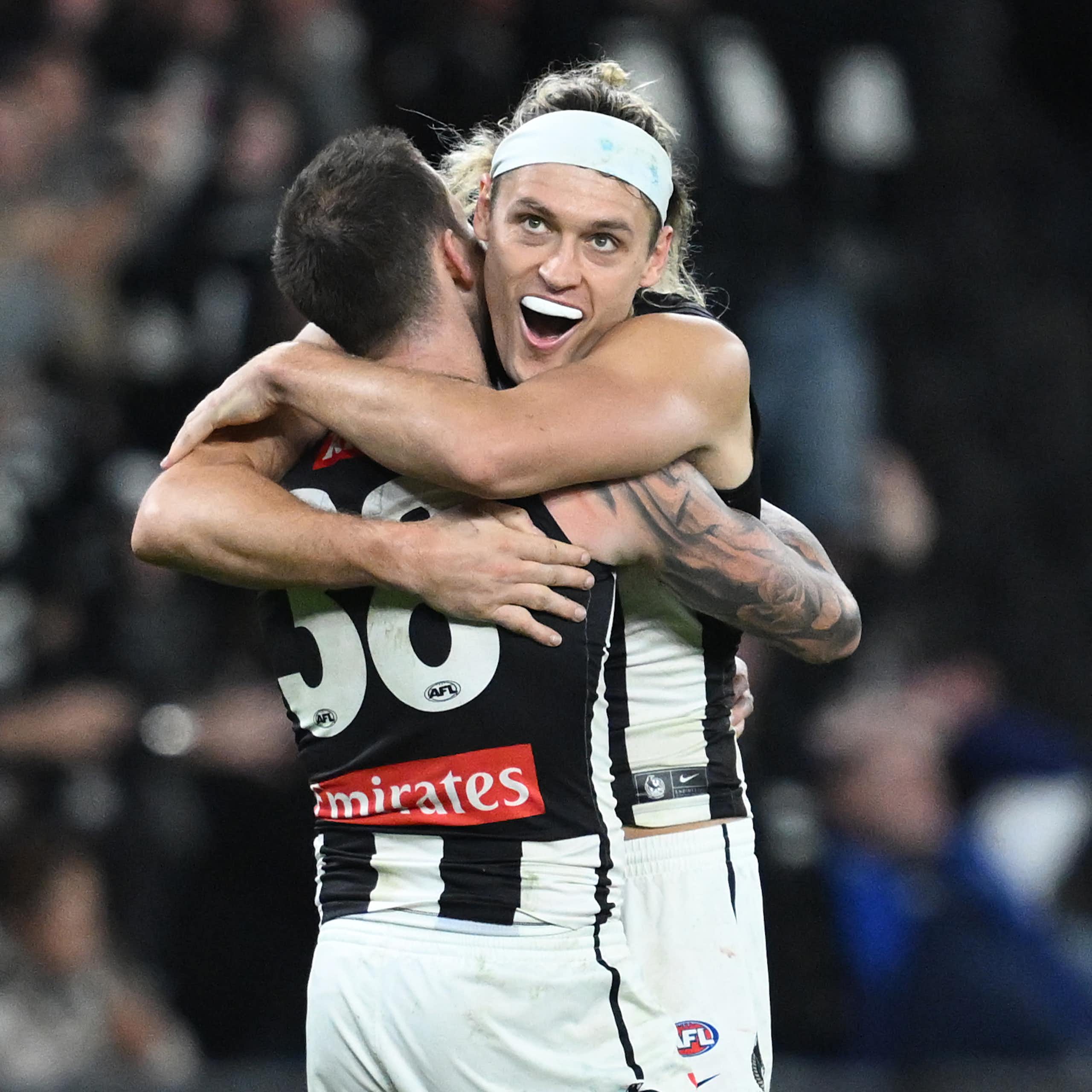 Collingwood players celebrate another remarkable comeback