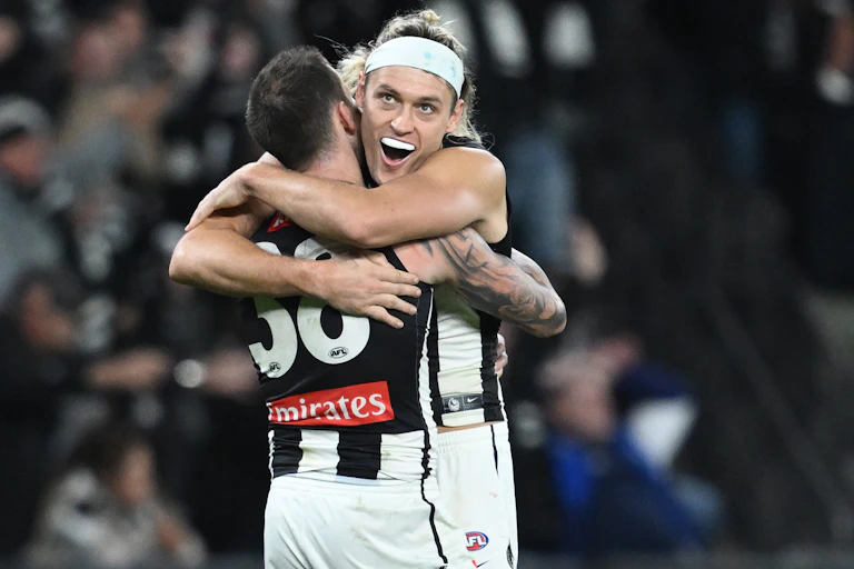Collingwood players celebrate another remarkable comeback
