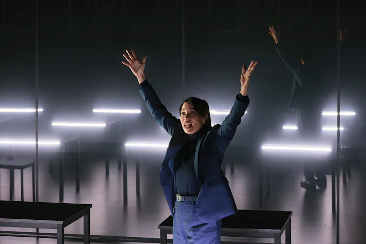 A woman with her hands outstretched.