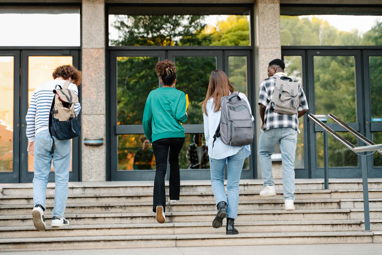 Students walking up steps to university building