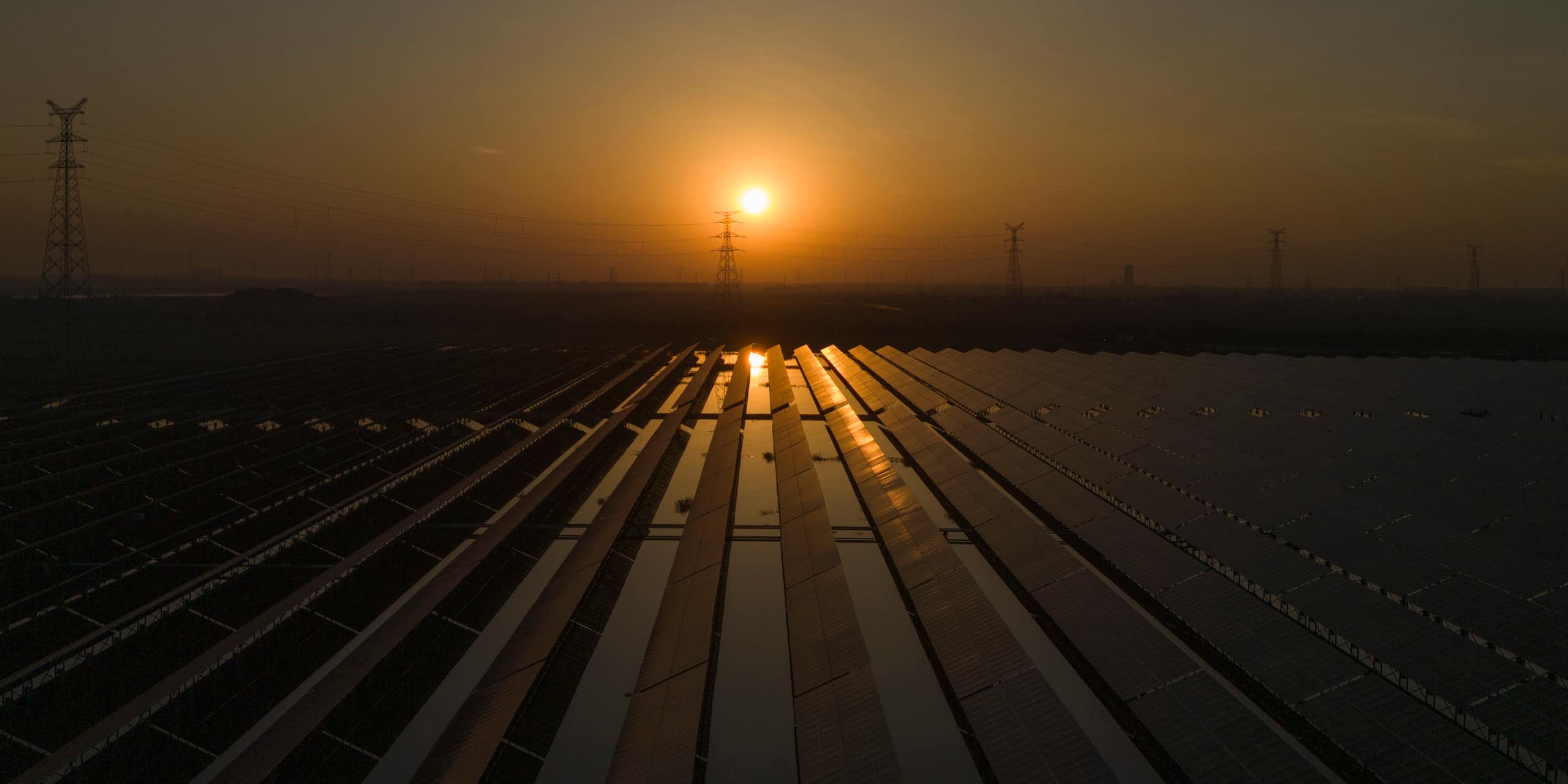 The sun sets over a solar farm.