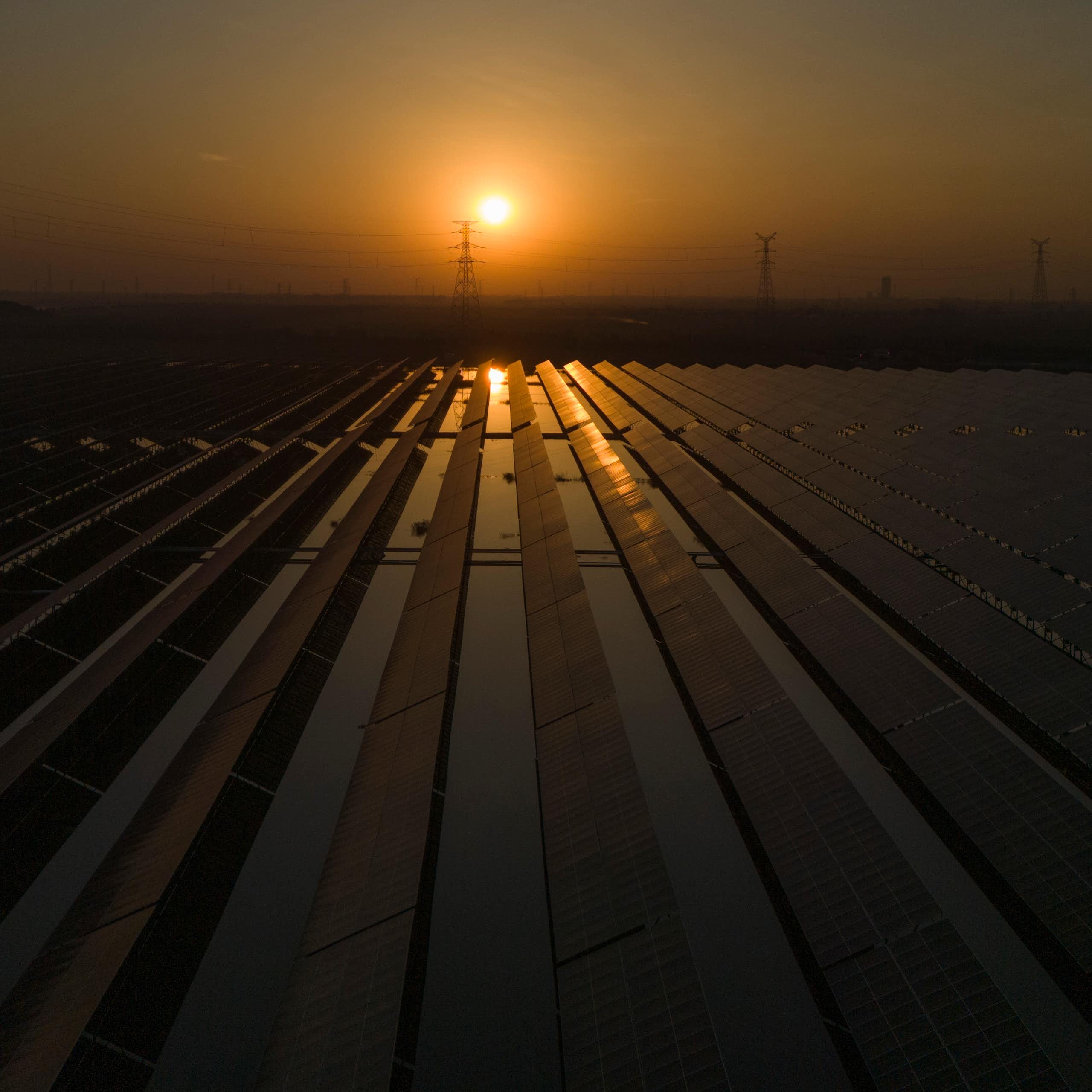 The sun sets over a solar farm.