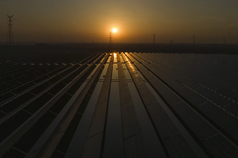 The sun sets over a solar farm.