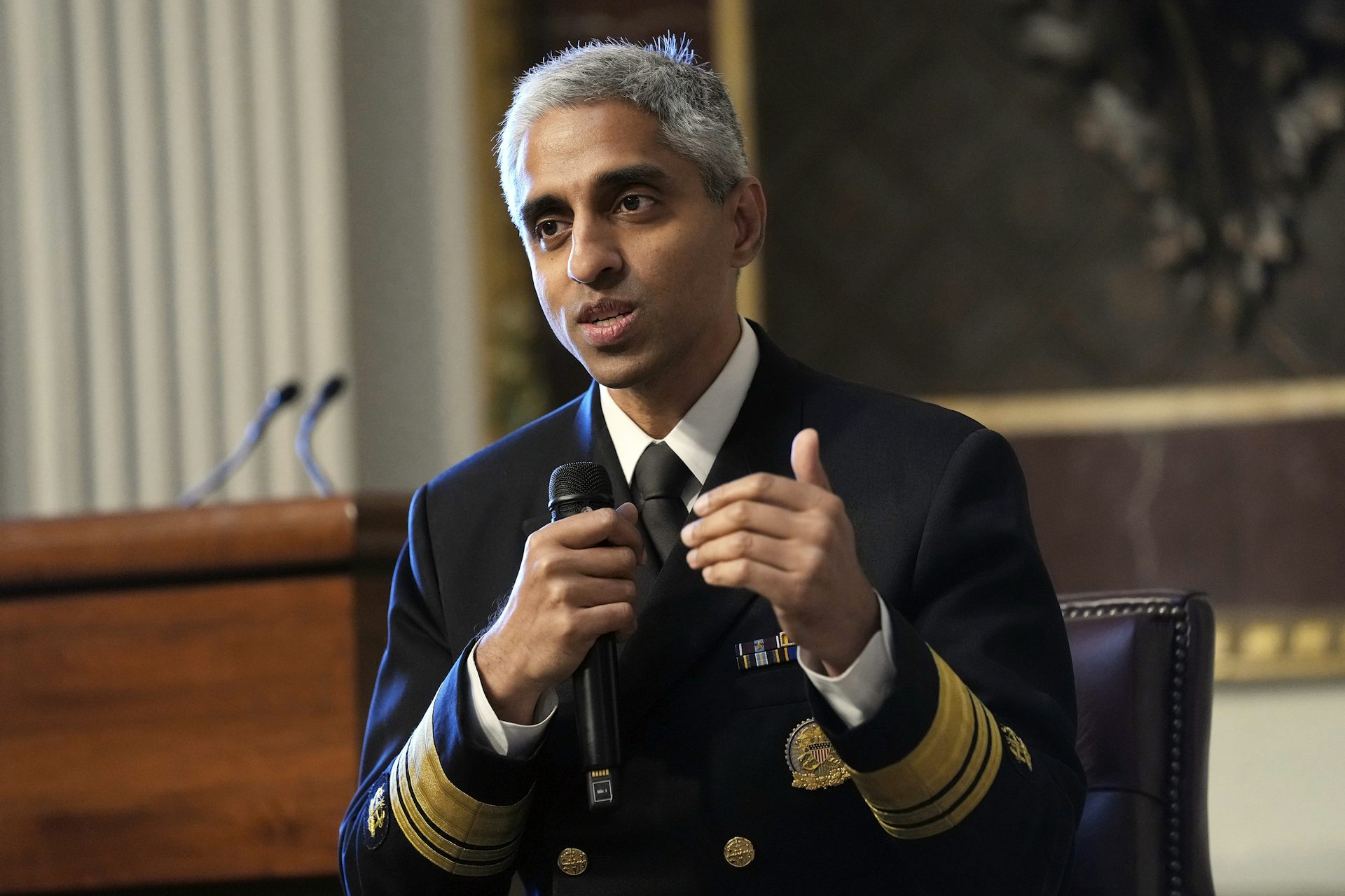 A man in military dress uniform holding a microphone