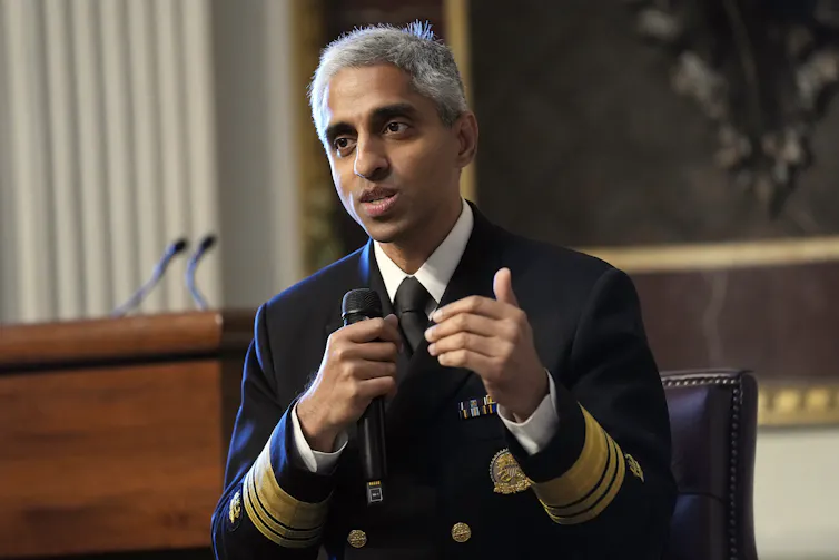 A man in military dress uniform holding a microphone