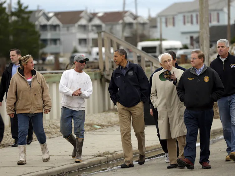 People walk down a street.